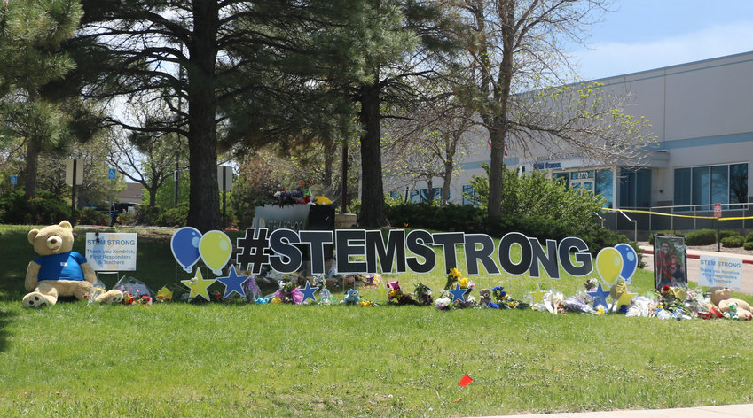 A memorial grows in the front of STEM School Highlands Ranch, where a shooting on May 7 left one student dead and eight others injured. Students were given the option to return to school on May 15.